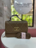 Cartera de mano en color café con acabado acolchado y correa ajustable a juego