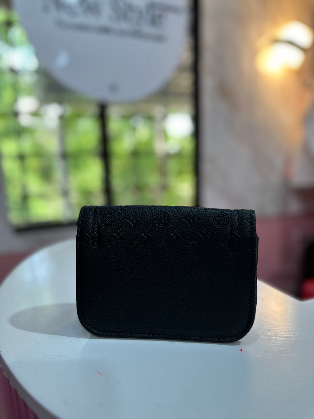Mini cartera en color negro con estampado elegante y correa ajustable