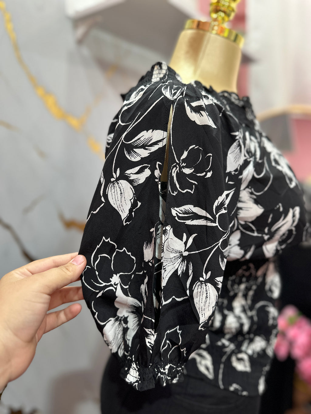Blusa negra con estampado floral blanco